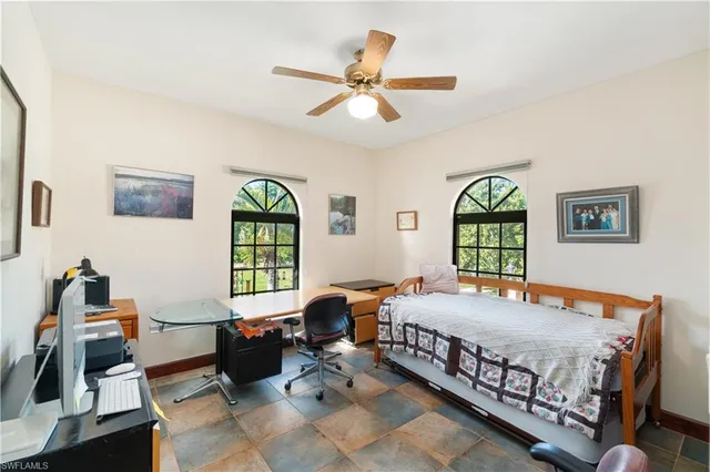 a bedroom with a bed and windows