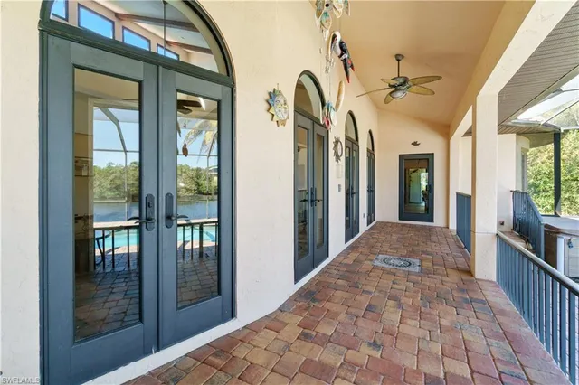 a view of a hallway with wooden floor and a livingroom