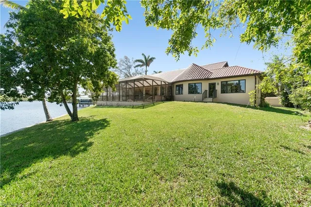 a front view of a house with yard and green space