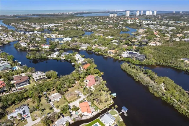an aerial view of lake and residential houses with outdoor space