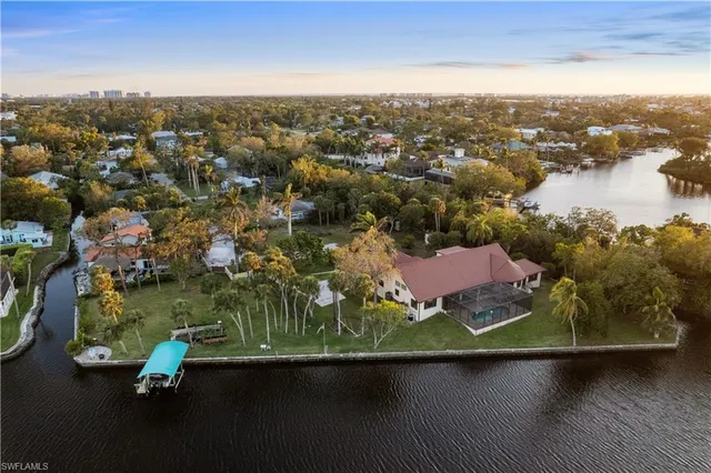 an aerial view of residential houses with outdoor space and ocean view