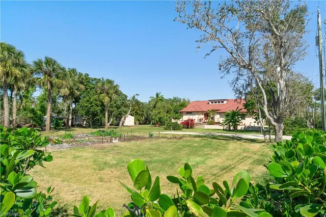 a backyard of a house with table and chairs
