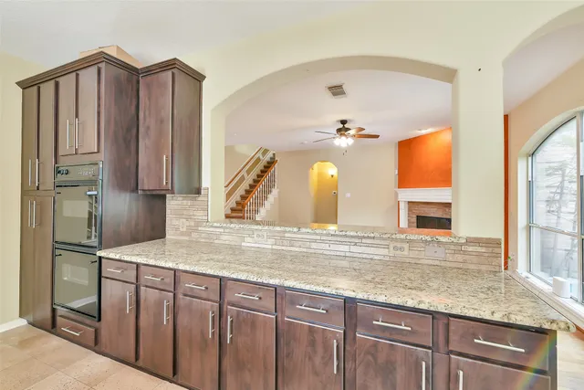 a kitchen with stainless steel appliances granite countertop a refrigerator and a sink