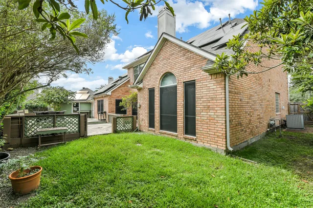 a view of a house with backyard sitting area and garden