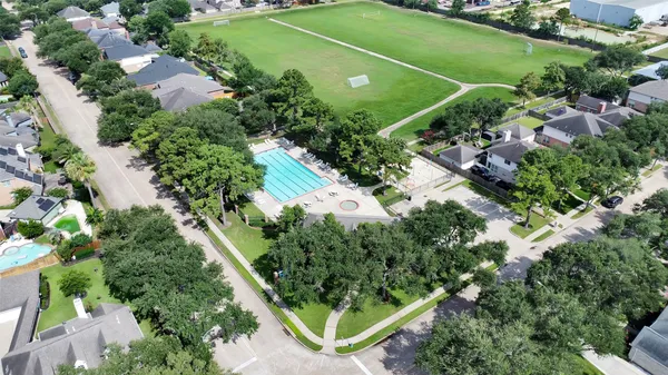an aerial view of a residential houses with outdoor space and street view