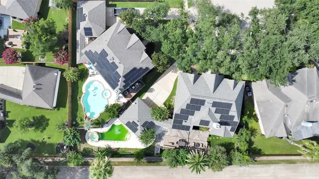 an aerial view of multiple houses with yard