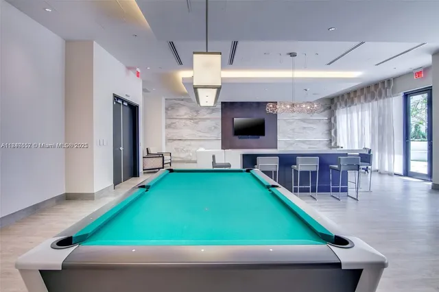 a view of a swimming pool with chairs and a fire pit