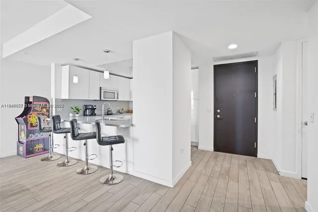 a view of kitchen with furniture and wooden floor