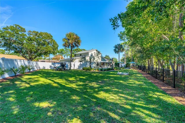 a swimming pool with outdoor seating yard and green space