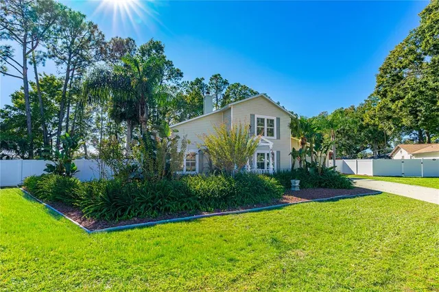 a view of a house with a yard and plants