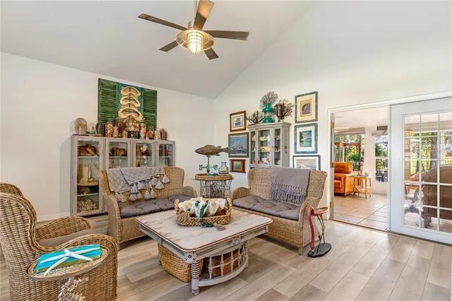 a living room with furniture a flat screen tv and a table