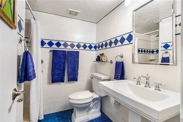 a bathroom with a walk in closet and wooden floor