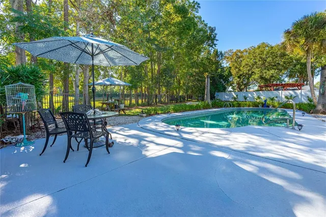a view of a backyard with a patio and garden