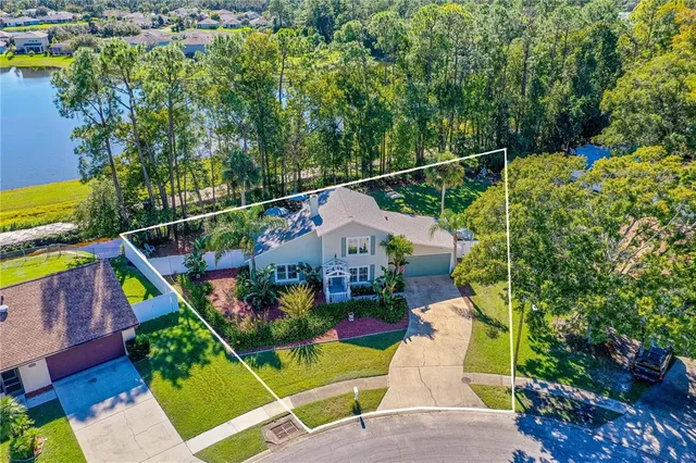 an aerial view of a residential houses with yard