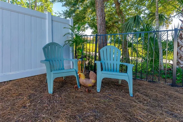 a view of a chairs in a backyard