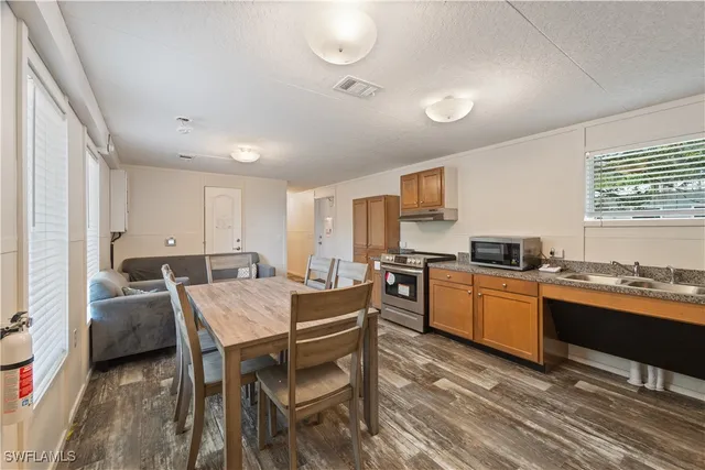 a kitchen that has a table and chairs in it