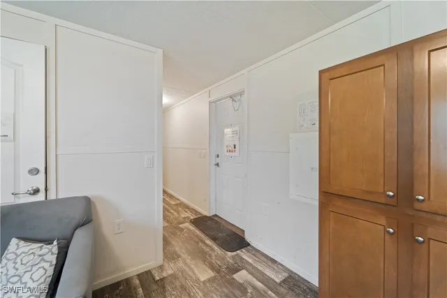 a view of a bedroom with wooden floor and furniture