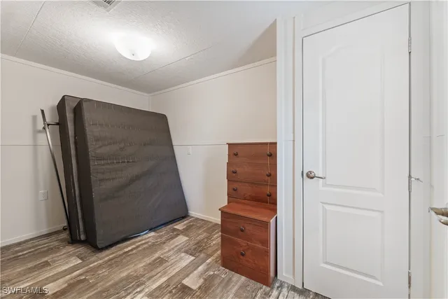 an empty room with closet and wooden floor