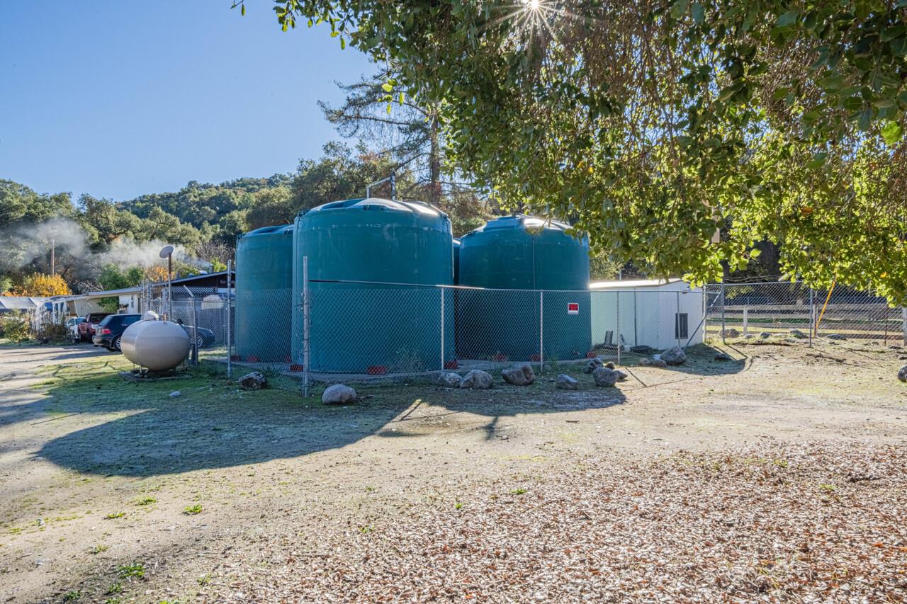 18842 Cachagua Road Carmel Valley, CA 93924 - Photo 25 of 35 a backyard of a house with a tree and wooden fence