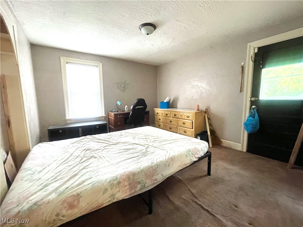 2409 Lake Rd Boulevard Northwest Canton, OH 44708 - Photo 12 of 21 Carpeted bedroom featuring multiple windows and a textured ceiling