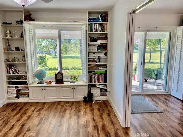 a living room with furniture and a book shelf
