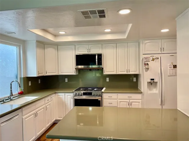 a kitchen with stainless steel appliances granite countertop a stove and a sink