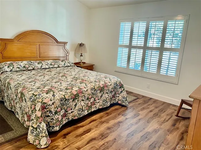 a bed sitting in a bedroom next to a window