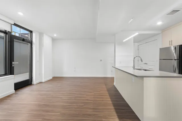 a view of a kitchen with a sink and a refrigerator