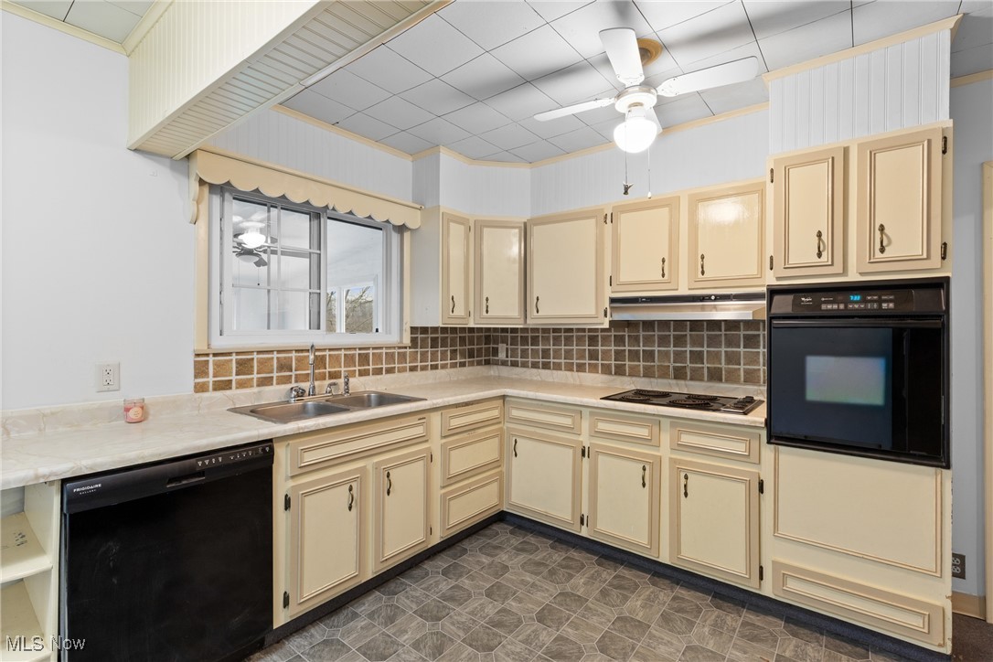 54885 Mt Victory Road Powhatan Point, OH 43942 - Photo 7 of 32 Kitchen featuring a ceiling fan, black appliances, light countertops, and cream cabinetry