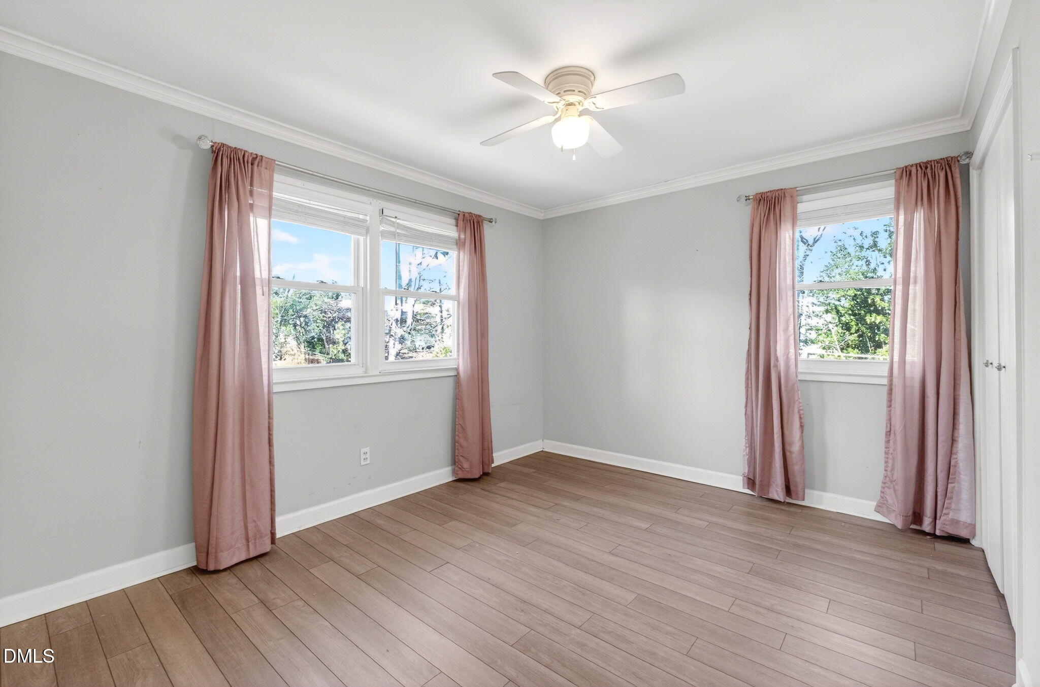 827 Daniels Street, Unit D Raleigh, NC 27605 - Photo 7 of 15 an empty room with wooden floor and windows