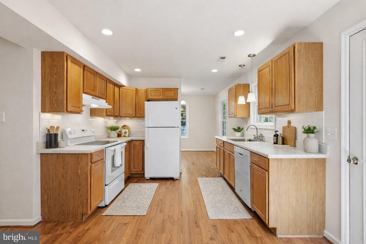 7168 Botha Road Bealeton, VA 22712 - Photo 14 of 36 a kitchen with white cabinets and stainless steel appliances