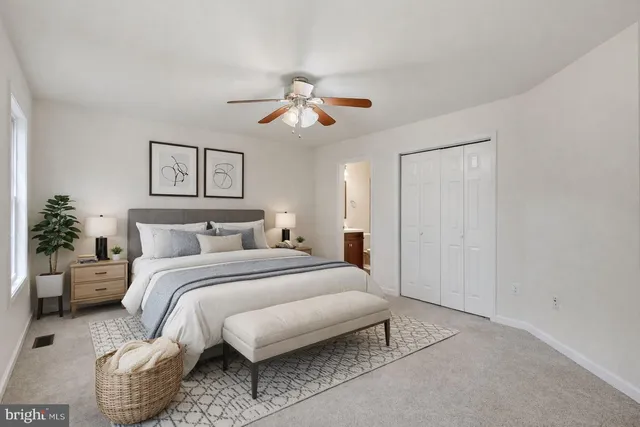 a bedroom with bed and a chandelier