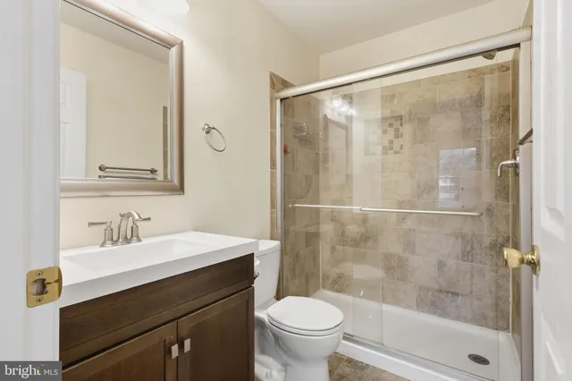 a bathroom with a sink mirror toilet and shower