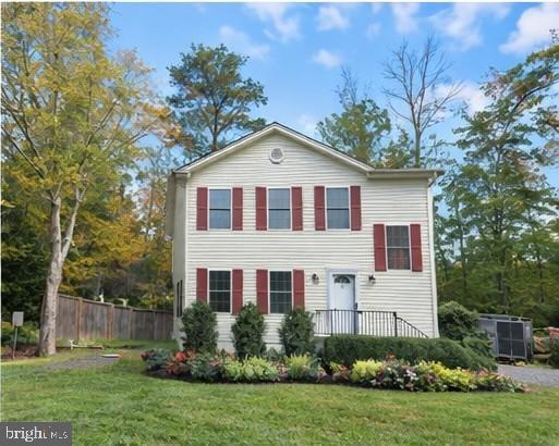 7168 Botha Road Bealeton, VA 22712 - Photo 3 of 36 a view of a yard in front of a house with plants and large trees