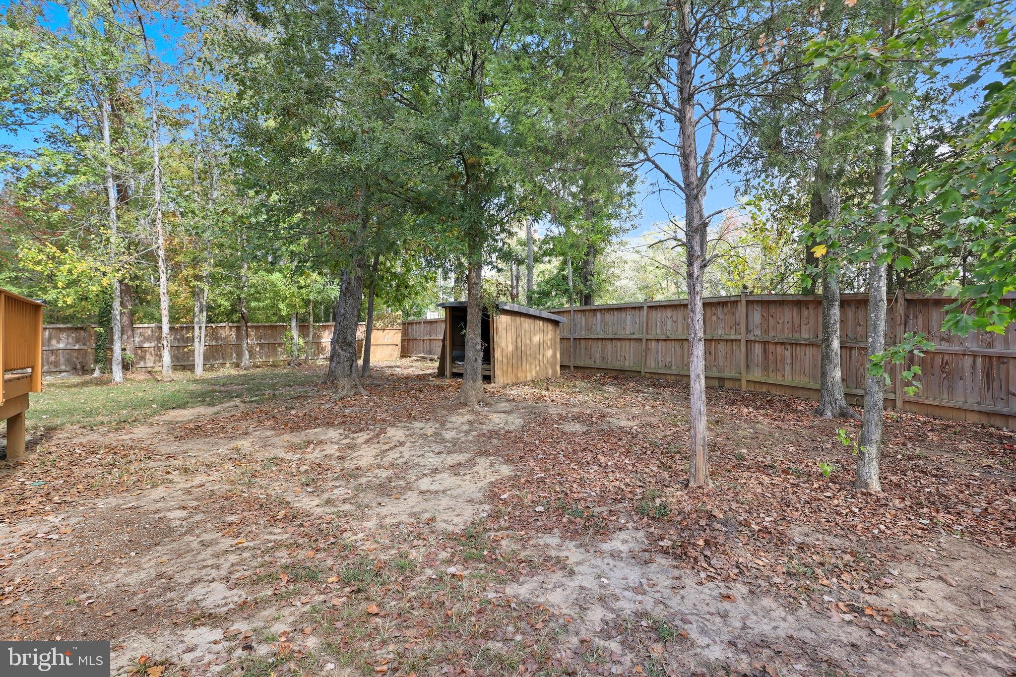 7168 Botha Road Bealeton, VA 22712 - Photo 35 of 36 a view of a backyard with large trees and wooden fence