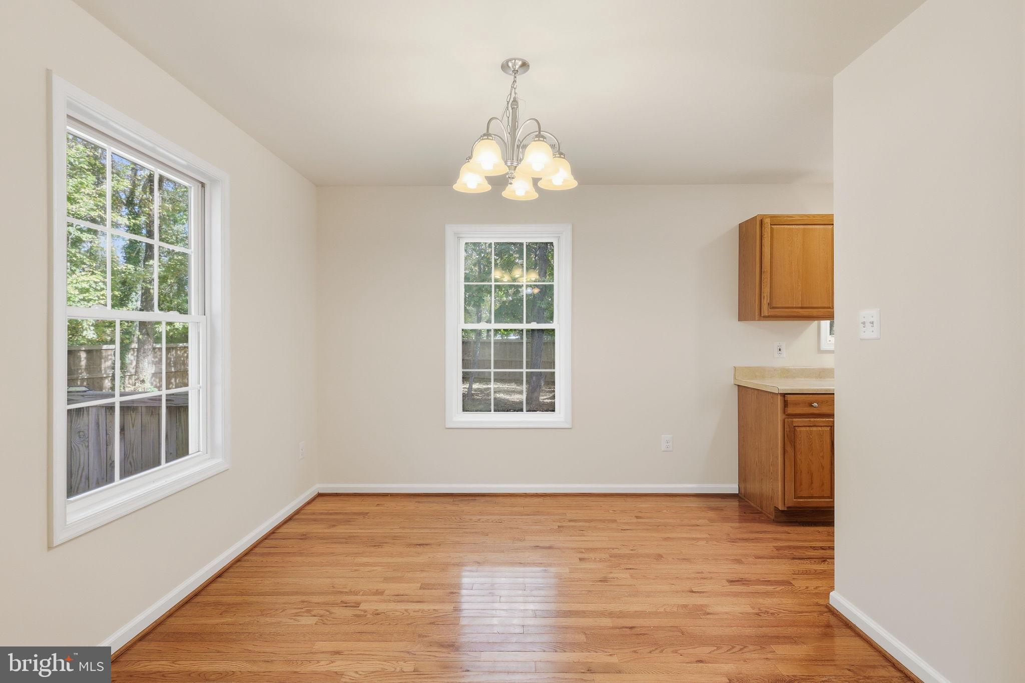 7168 Botha Road Bealeton, VA 22712 - Photo 10 of 36 a view of an empty room with wooden floor and a window