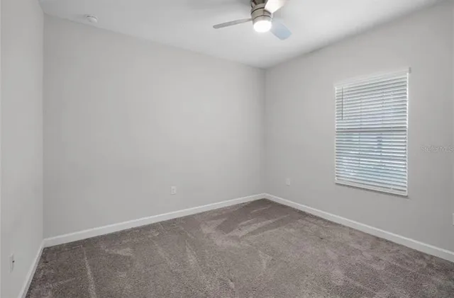 a kitchen with stainless steel appliances kitchen island granite countertop a table chairs and a wooden floor