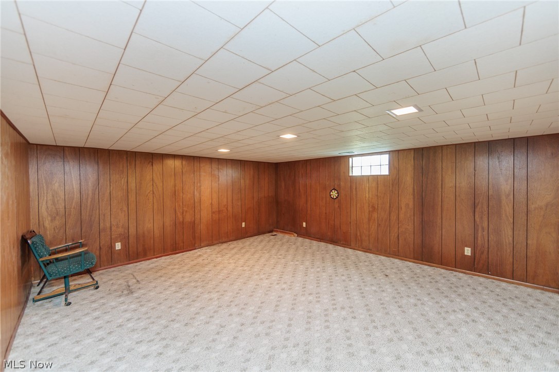 2170 Norton Road Stow, OH 44224 - Photo 45 of 48 Spacious room featuring wood paneling, drop ceiling with recessed lighting, light-toned patterned carpeting, and an egress window