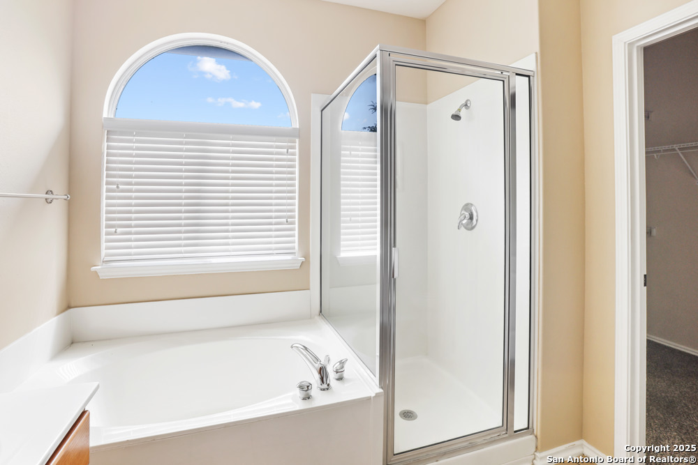 157 Crimson Tree Cibolo, TX 78108 - Photo 18 of 27 a bathroom with a bathtub and a shower