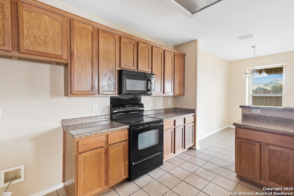 157 Crimson Tree Cibolo, TX 78108 - Photo 10 of 27 a kitchen with stainless steel appliances granite countertop a stove a sink and a microwave