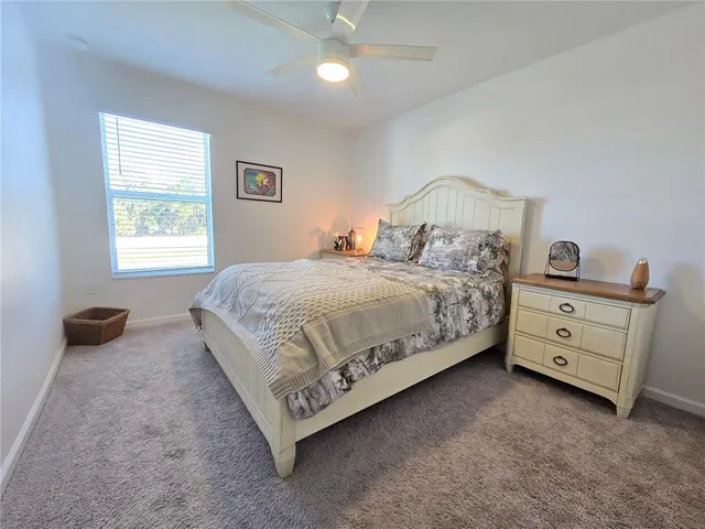 a bedroom with a bed and a lamp