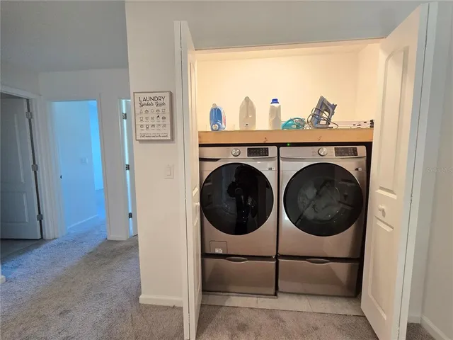 a view of a hallway with wooden floor and closet