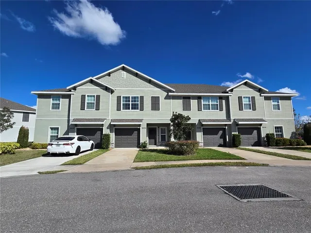 a view of a house with a patio and a yard
