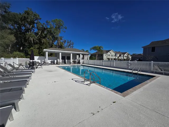 a view of a swimming pool with a lounge chair