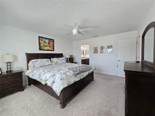 a bedroom with a bed and a desk