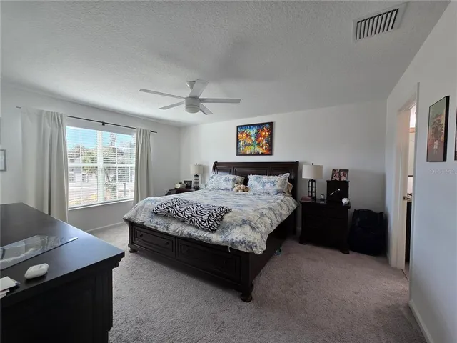 a spacious bathroom with a granite countertop sink mirror and a bath tub