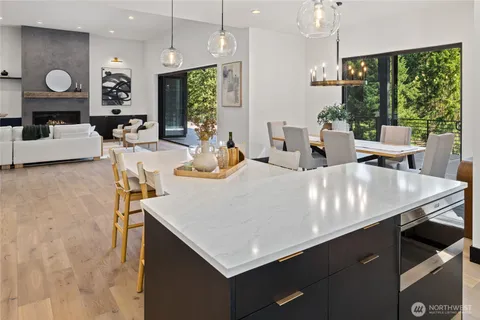 a large kitchen with a table chairs and a large window