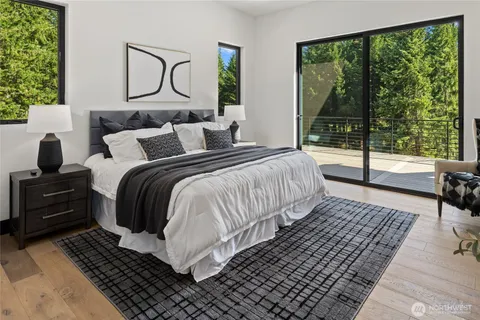 a bedroom with a bed and large window