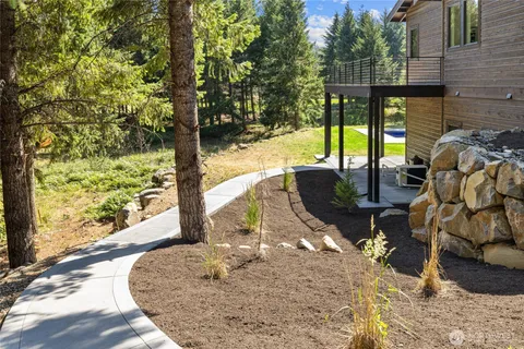 a view of a porch with furniture and floor to ceiling window