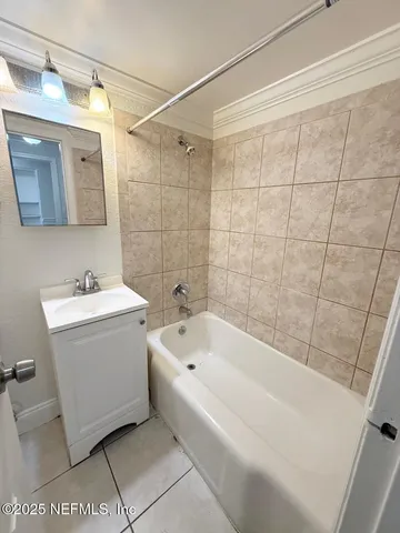 a bathroom with a sink a bathtub and shower